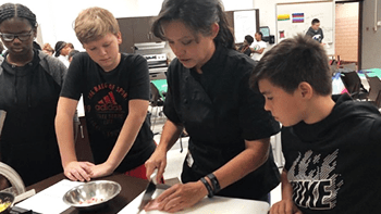 JDG Middle School Program students working with a chef